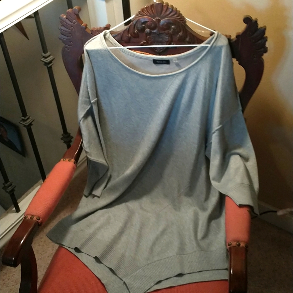 This Is a grey light knit sweater never worn!